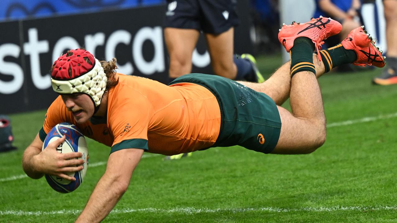 TOPSHOT - Australia's flanker Fraser McReight dives and scores a try during the France 2023 Rugby World Cup Pool C match between Australia and Portugal at Stade Geoffroy-Guichard in Saint-Etienne, south-eastern France, on October 1, 2023. (Photo by Olivier CHASSIGNOLE / AFP)