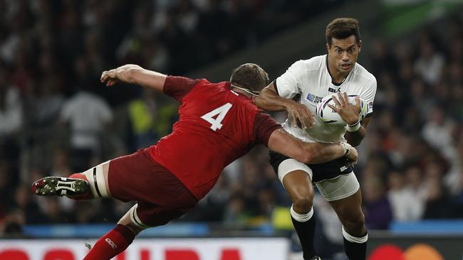 Fiji's fly-half Ben Volavola (R) is tackled by England's lock Geoff Parling during the opening match of the 2015 Rugby World Cup.