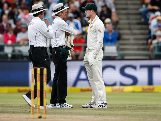 Umpires Richard Illingworth (left) and Nigel Llong confront Bancroft, who initially tried to deflect with lies before confessing.