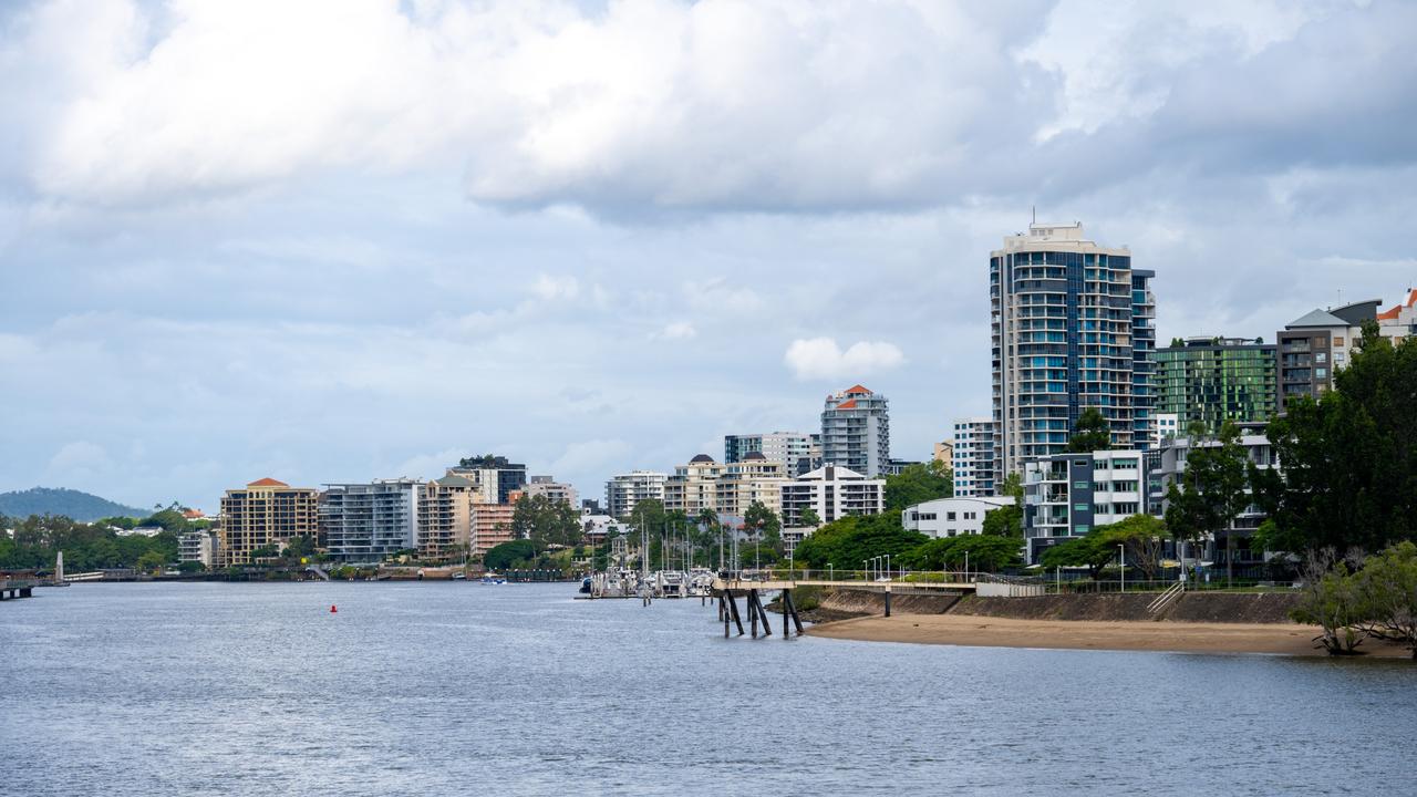 Developing Queensland – A residential area seen behind the Brisbane River in Brisbane, Australia, a cloudy day in the summer.