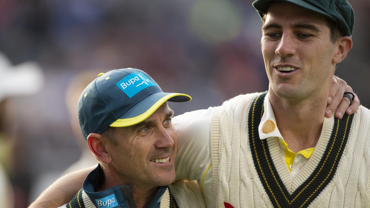 Australia Coach Justin Langer celebrates with bowler Pat Cummins