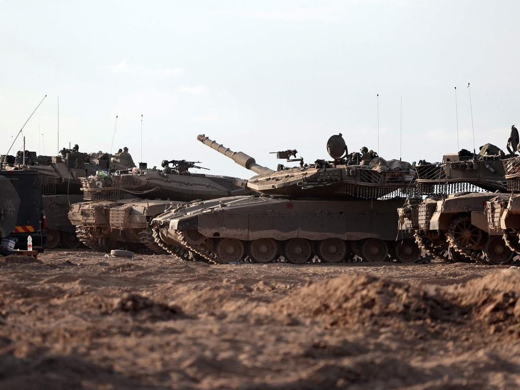 Israeli tanks gather in a field near the kibbutz Beeri in southern Israel. Picture: AFP