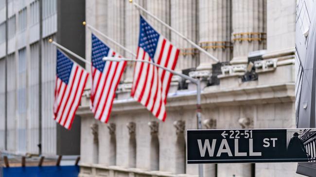 Wall street sign with New York Stock Exchange background New York City, New York, USA.