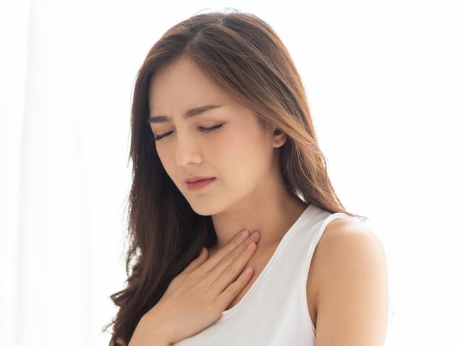 Asian Beautiful Woman with Acid Reflux on her bed. Illness, Disease, Symptom. Picture: Istock