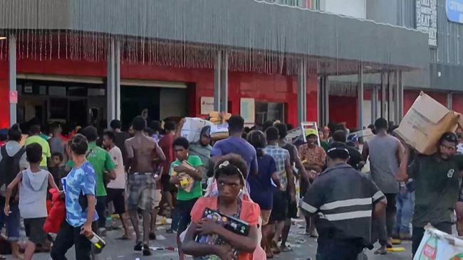 Ten people were killed in PNG during riots and looting on January 10 following a public sector pay “glitch”. Police stood by and watched the chaos unfold. Picture: AFP