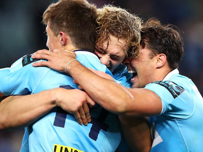 SYDNEY, AUSTRALIA - JULY 21: Alex Newsome, Ned Hanigan and Nick Phipps of the Waratahs celebrate victory during the Super Rugby Qualifying match between the Waratahs and the Highlanders at Allianz Stadium on July 21, 2018 in Sydney, Australia. (Photo by Mark Kolbe/Getty Images)