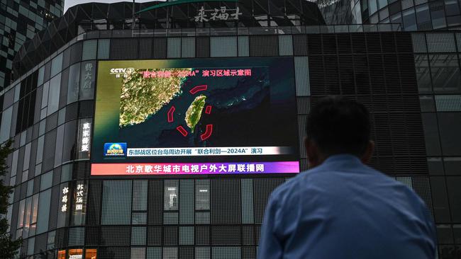 An outdoor screen in Beijing shows coverage of China’s military drills around Taiwan on May 23. Picture: AFP