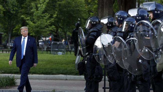 US President Donald Trump walks past police in Lafayette Park after he visited St John's Church across from the White House. Picture: AP