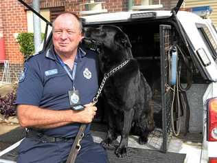 COMMUNITY HERO: Dog handler Sergeant Bill Applebee with Angel. Picture: Mike Knott BUN060718BILL4