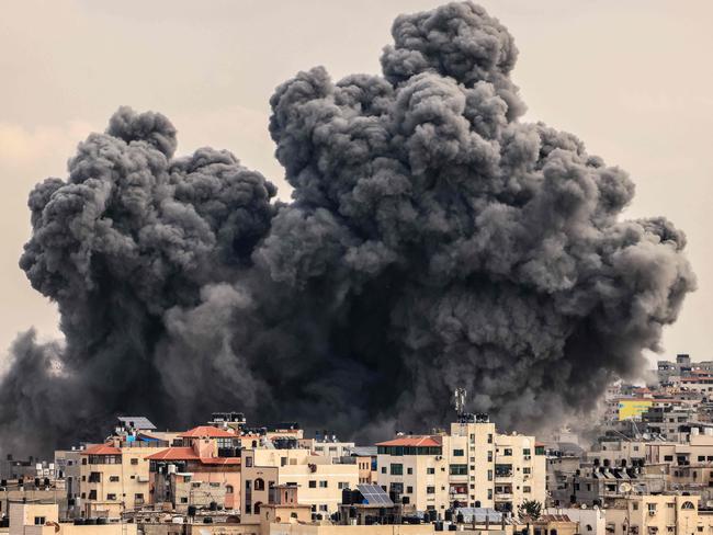 A plume of smoke rises in the sky of Gaza City during an Israeli air strike. Picture: Mahmud Hams/AFP