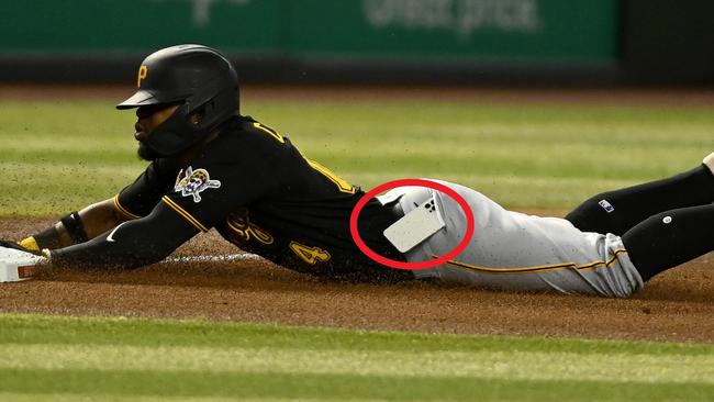 PHOENIX, ARIZONA - AUGUST 09: Rodolfo Castro #14 of the Pittsburgh Pirates slides into third base as his cell phone falls out of his pocket during the fourth inning of a game against the Arizona Diamondbacks at Chase Field on August 09, 2022 in Phoenix, Arizona. (Photo by Norm Hall/Getty Images)