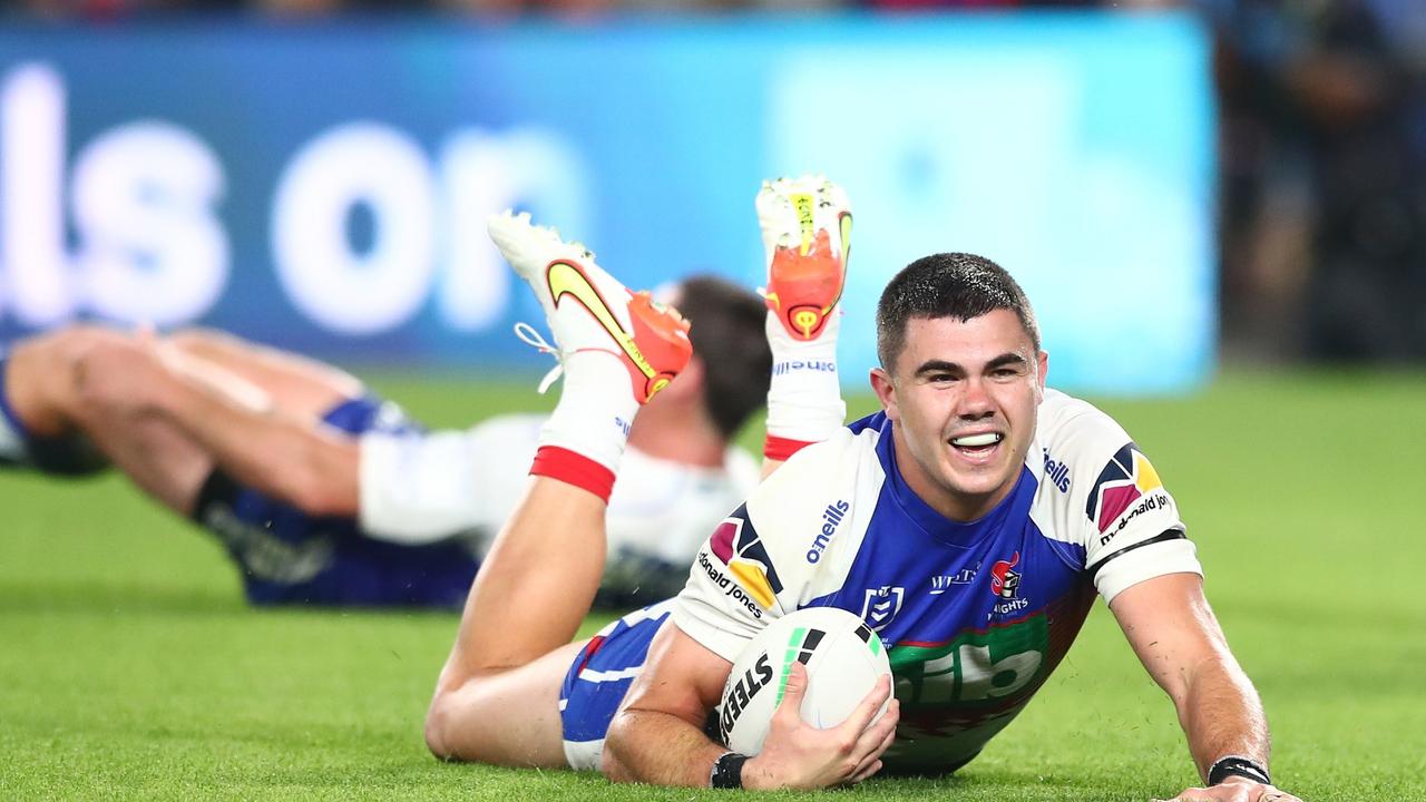 GOLD COAST, AUSTRALIA - AUGUST 21: Jake Clifford of the Knights scores a try during the round 23 NRL match between the Canterbury Bulldogs and the Newcastle Knights at Cbus Super Stadium, on August 21, 2021, in Gold Coast, Australia. (Photo by Chris Hyde/Getty Images)