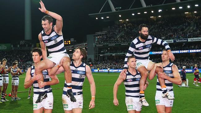 Corey Enright and Jimmy Bartel are chaired off after their milestone games.