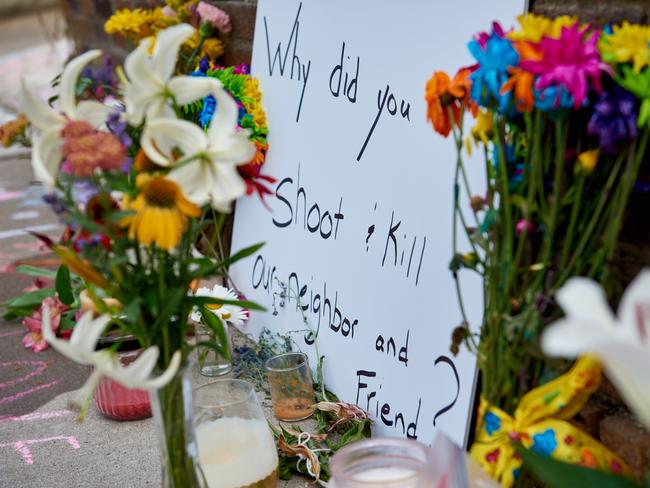 Chalk messages and a sign left where Justine Damond was killed. Picture: Jules Ameel