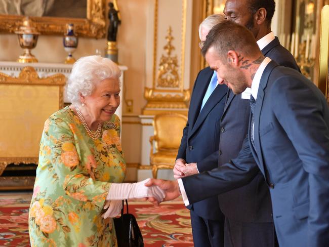 The Queen greets David Beckham at the ceremony. Picture: Getty Images