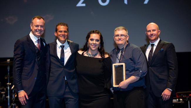 (Centre) Deborah and Darren Ramm receiving the Big Red Award.