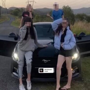 Youths posing with a Ford Mustang allegedly stolen from an address in Helensvale. The photo was posted to social media.