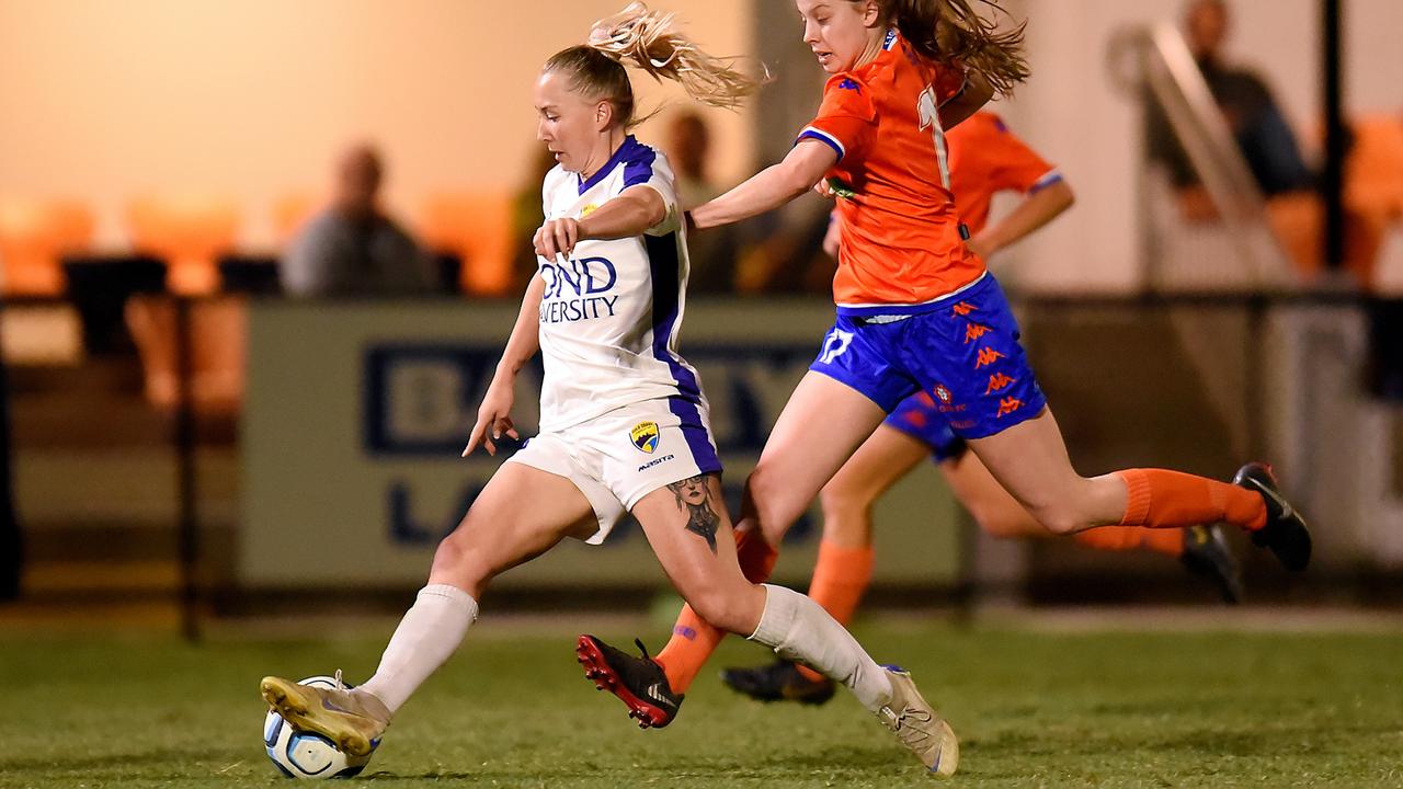 Gold Coast United’s Deeanna Thompson holds off a Lions FC player.