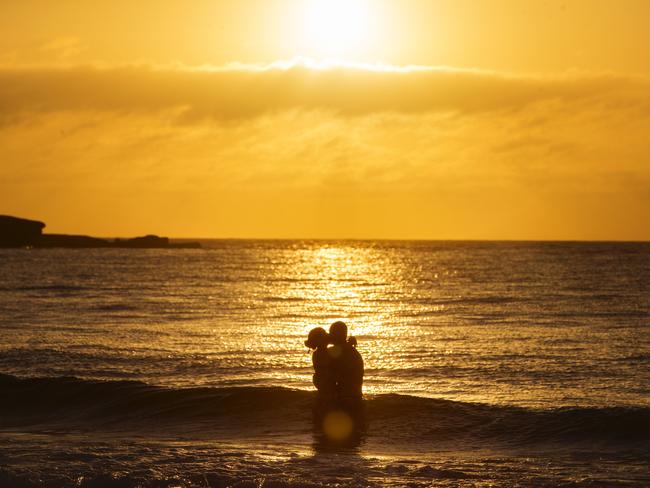 Phew! ... A couple cool off at Bondi Beach ahead of the big heat today. Picture: Jenny Evans