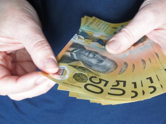 POV (Point of view) of young adult Australian woman counting cash of Australian dollar banknotes close up.