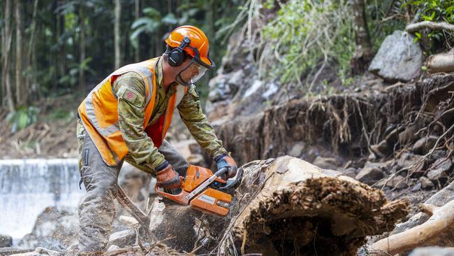 Defence personnel from 3rd Brigade prepare to leave Lavarack Barracks to in help in Operation Flood Assist. Australian Army sapper Lance Corporal Jack Dalrymple uses a chainsaw to assist Lismore Shire Council clear away debris from Mulgum Creek Weir in Nimbin, New South Wales, as part of Operation Flood Assist 2022. Picture: Defence.