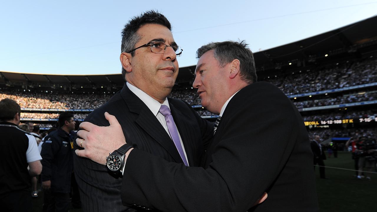 Demetriou and McGuire embrace after Collingwood’s 2010 grand final win.