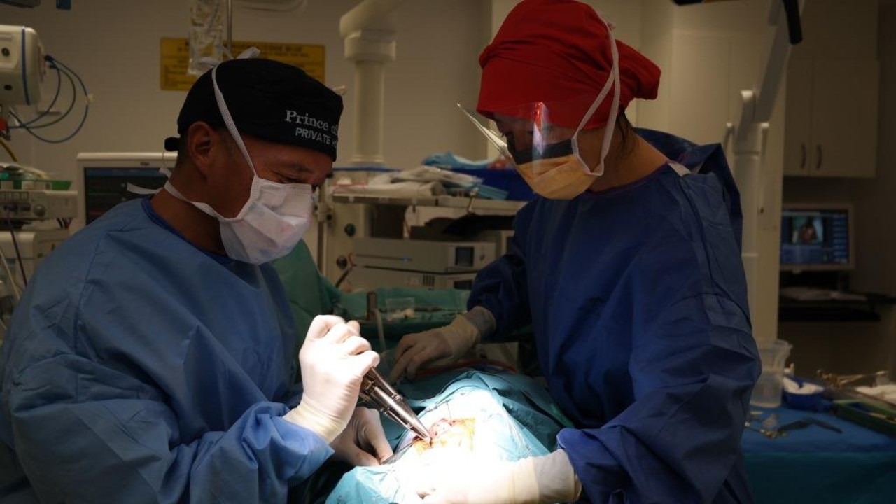 Dr Charlie Teo at work with nurse Young Je in the operating theatre. Picture: Supplied