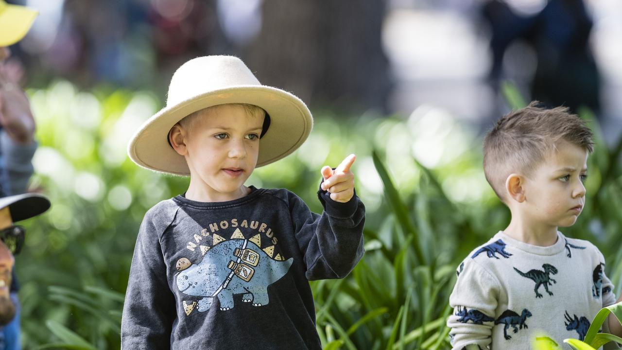 Ashton (left) and Luca Freeman watch the march to the Mothers' Memorial for the mid-morning Toowoomba Anzac Day service, Tuesday, April 25, 2023. Picture: Kevin Farmer