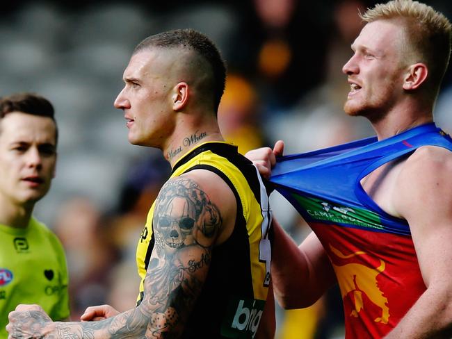 Dustin Martin of the Tigers (L) tussles with Nick Robertson of the Lions.