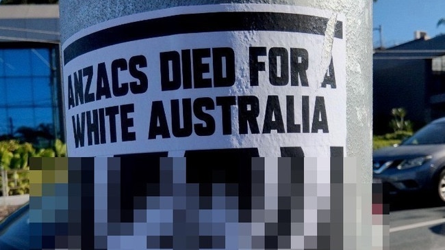 Police alerted after racist posters plastered at sites in inner Brisbane.