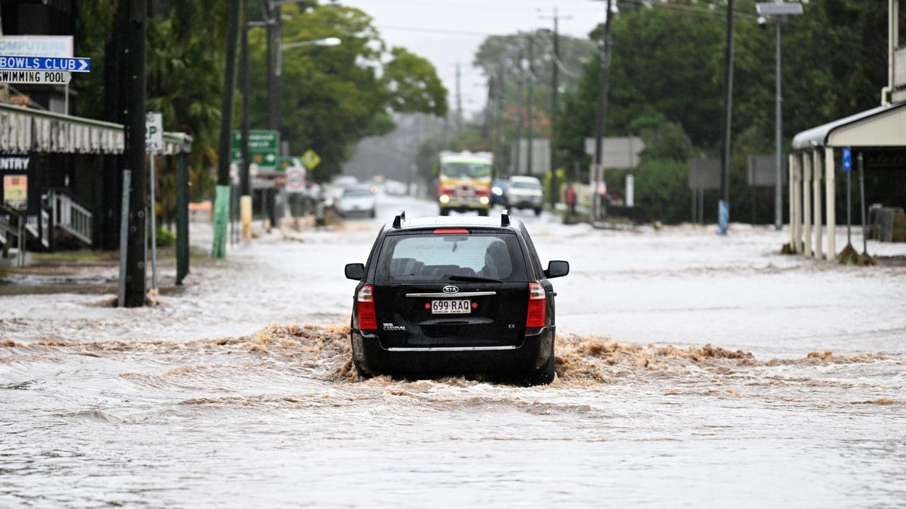 A car drives through floodwater at Laidley. Picture: Dan Peled/Getty Images