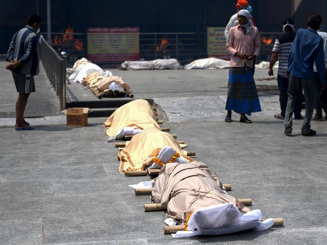 Bodies of coronavirus victims lined up before cremation in New Delhi. Picture: AFP