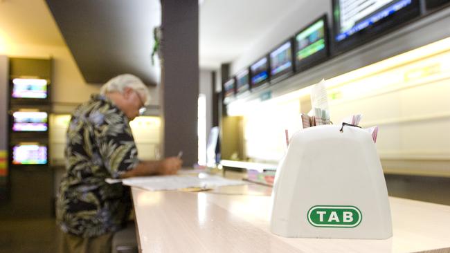 A punter has a bet in a pub at Lismore. Picture: Jerad Williams / The Northern Star, File