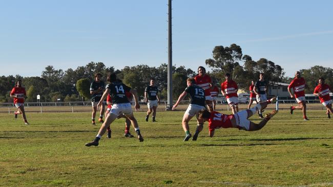 Spectators cheer on as they watch the B Grade St George vs Condamine match at the Roma Rugby Races at Bassett Park. Picture: Chloe Cufflin.