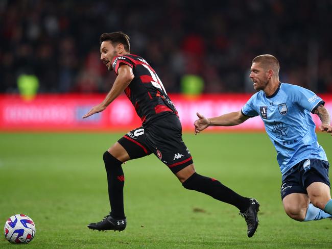 Wanderers star Milos Ninkovic (left) evades his former teammate Luke Brattan. Picture: Jason McCawley/Getty Images