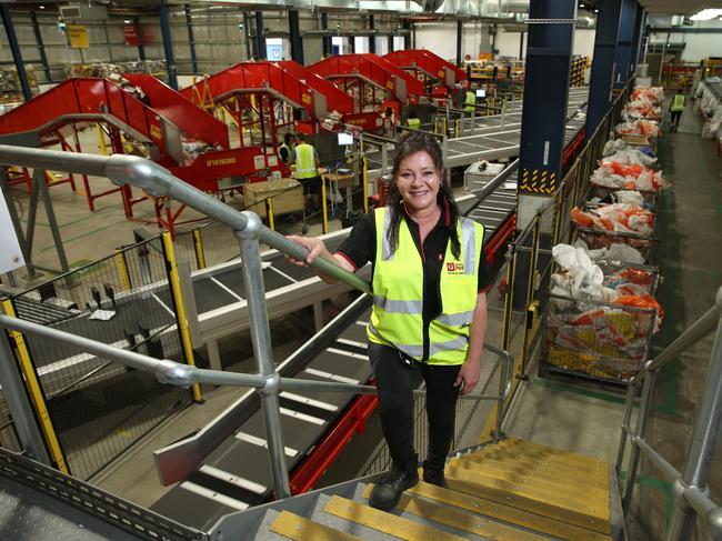 16/10/2020. Merima Mahmic, night-shift manager at Australia Post Alexandria depot in Sydney pictured with new sorting machines that have recently been installed to handle the booming surge of parcels flooding into Australia. Britta Campion / The Australian