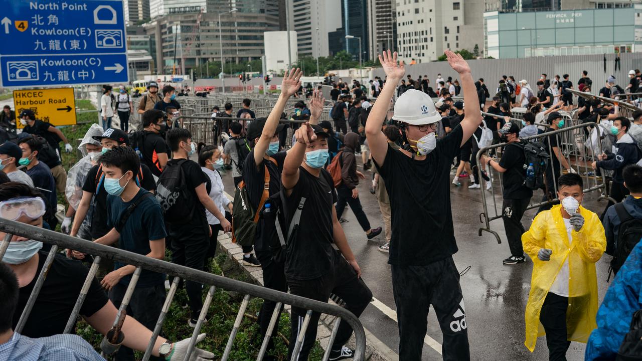 Protesters move barricades to block the street near the government headquarters. Picture: Anthony Kwan/Getty Images