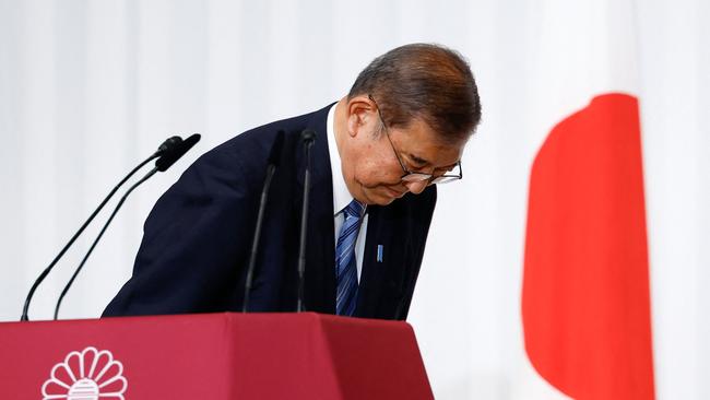 Shigeru Ishiba, Japan's Prime Minister and leader of the ruling Liberal Democratic Party, bows to LDP lawmakers onstage after a press conference at the party's headquarters in Tokyo on October 28, 2024. (Photo by Kim Kyung-Hoon / POOL / AFP)