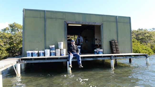 Peter Clift has a break outside the small shed where they process the oysters.