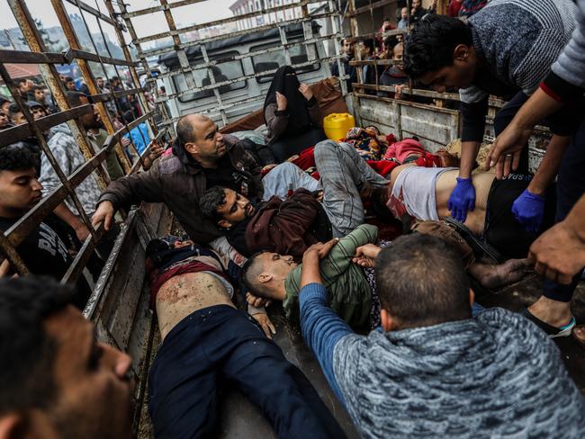 Palestinians injured in an Israeli air strike arrive on the back of a truck at Nasser Medical Hospital in Khan Younis, Gaza. Picture: Getty Images