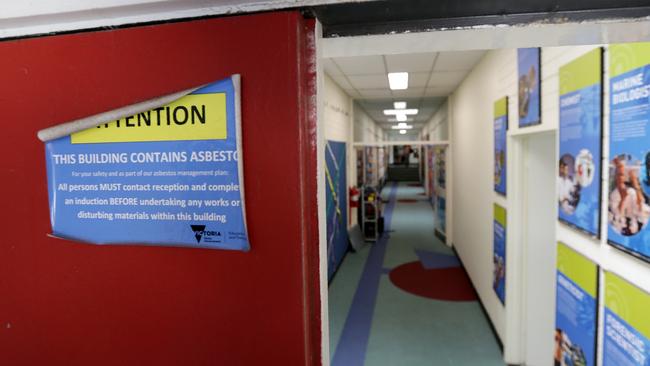 Signs around the school warn it contains asbestos.