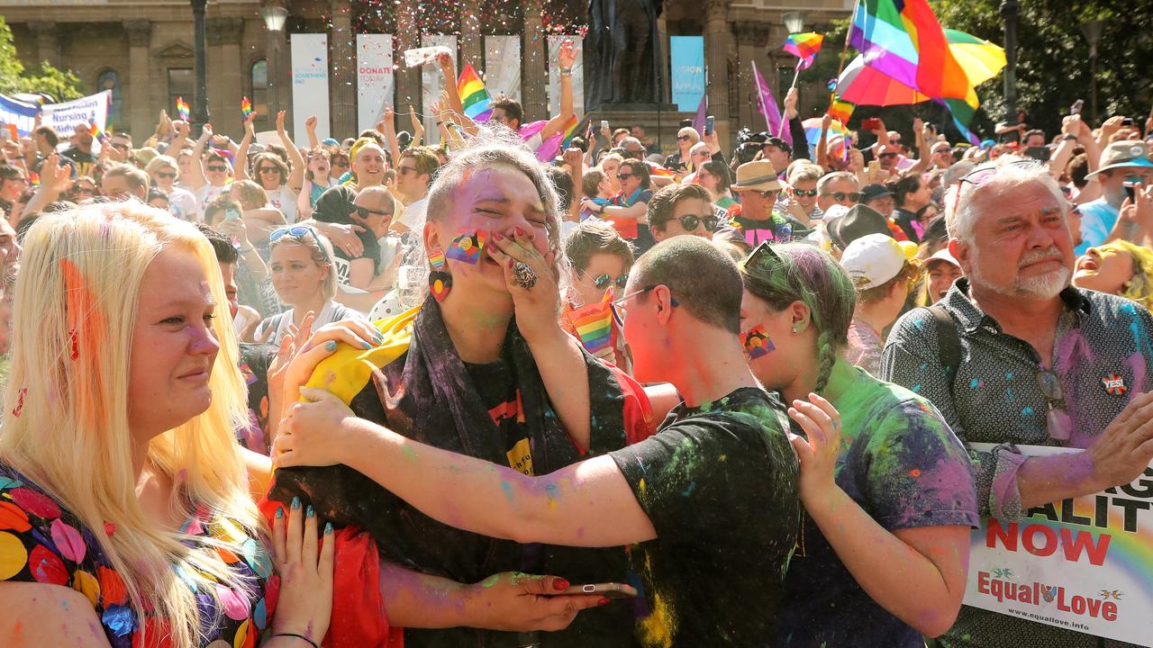 'Yes' supporters celebrate outside the State Library in Melbourne after watching the live result of the Same Sex Marriage Plebiscite on TV.