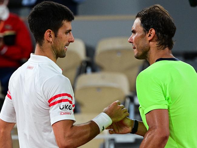 Serbia's Novak Djokovic (L) and Spain's Rafael Nadal shake hands at the end of their men's singles semi-final tennis match on Day 13 of The Roland Garros 2021 French Open tennis tournament in Paris on June 11, 2021. (Photo by MARTIN BUREAU / AFP)