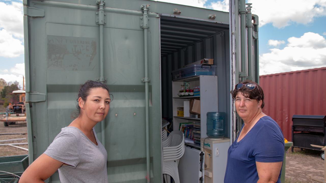 Lockyer Valey RDA volunteer Siranee Parkinson and Secretary Bobbi Dingle with one of the shipping containers broken into.