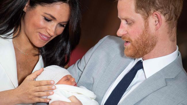 Britain's Prince Harry and his wife Meghan, Duchess of Sussex, pose for a photo with their newborn baby son, Archie Harrison Mountbatten-Windsor, in St George's Hall at Windsor Castle in 2019.