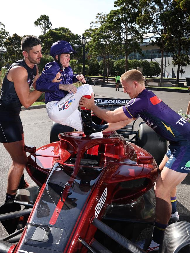 Pittonet and Melbourne Storm player Tyran Wishart help pull Williams out of the Australian Grand Prix Formula 1 after the Mad March shoot. Picture: David Caird