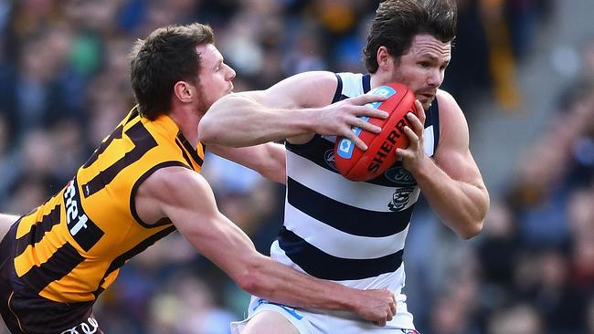 Patrick Dangerfield marks over the top of Blake Hardwick.