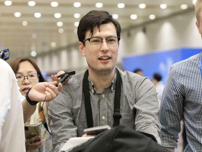 Australian student Alek Sigley smiles as he arrives at the airport in Beijing. Picture: Kyodo News via AP