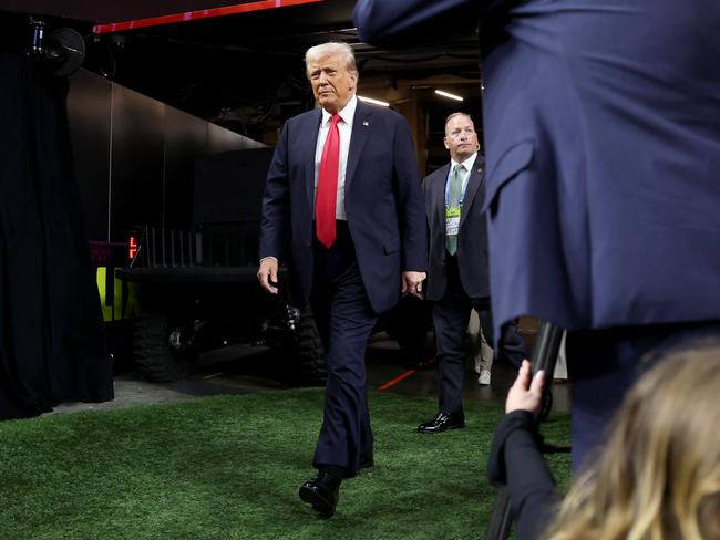 Donald Trump walks onto the field at Caesars Superdome. Picture: Getty Images