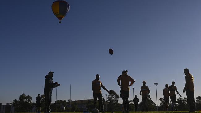 A hot-air balloon flys over an ACT Brumbies Super Rugby training session at the University of Canberra yesterday. Picture: AAP